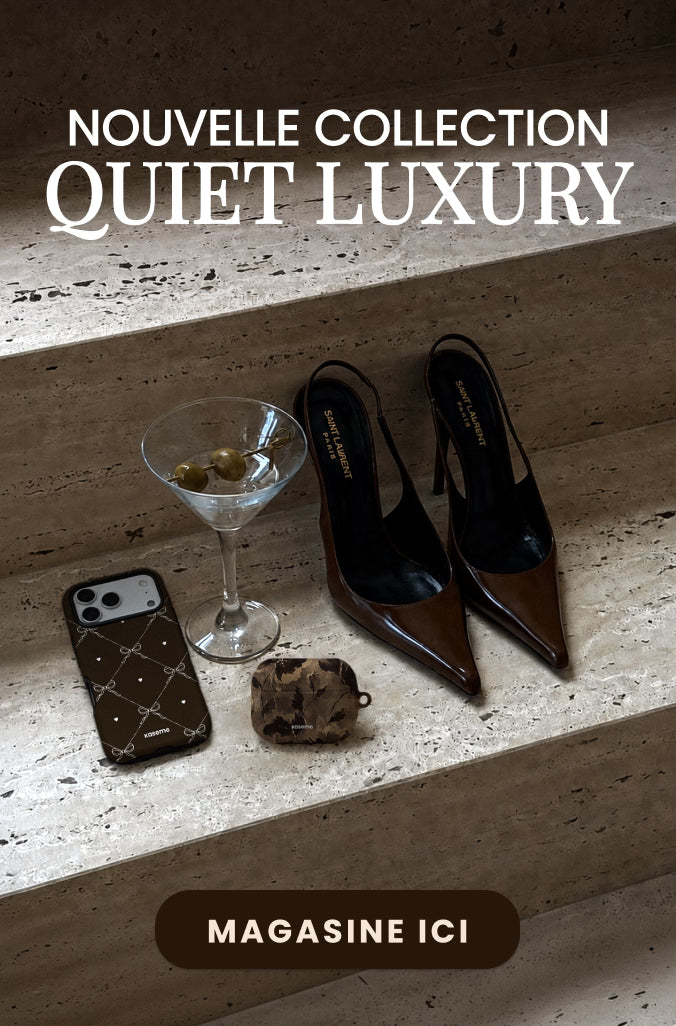 A styled editorial flat-lay on stone steps featuring a pair of dark brown pointed-toe slingback heels, a black quilted phone case, a small brown patterned pouch, and a martini glass with olives. Large white text at the top reads 'NOUVELLE COLLECTION QUIET LUXURY' and a dark brown banner at the bottom reads 'MAGASINE ICI'.