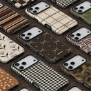 A collection of autumn phone cases arranged diagonally on a textured brown background, showcasing various patterns including stripes, plaid, houndstooth, zebra print, and camouflage.